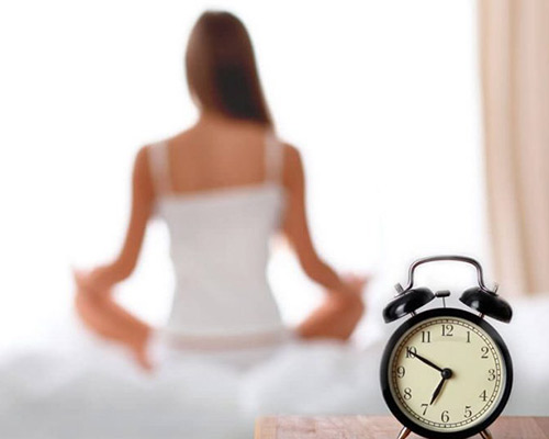Woman in background with alarm clock